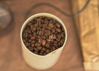 Fototapeta premium Coffee beans in a home coffee grinder