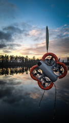 Drone Being Rescued from Water After Crash, Hanging from a Fishing Rod.