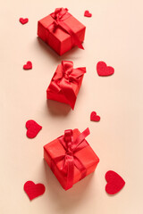 Gift boxes and hearts on beige background. Valentine's Day celebration