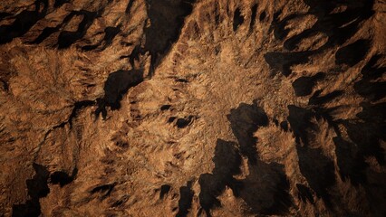 Beneath the fading light, rugged mountain slopes reveal an intricate tapestry of shadows and textures.