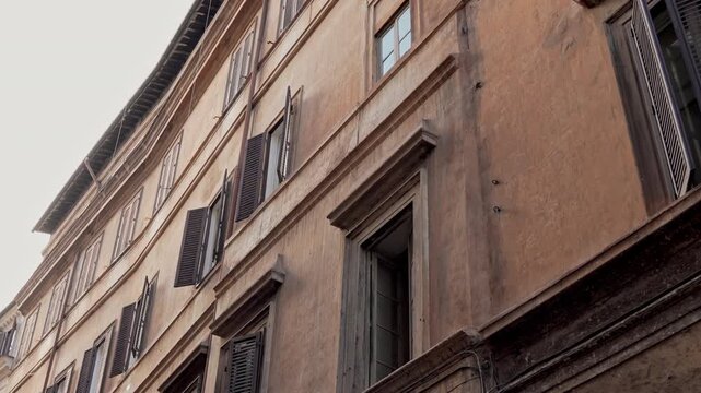 Charming Roman Building With Traditional Shuttered Windows And Historic Facade View