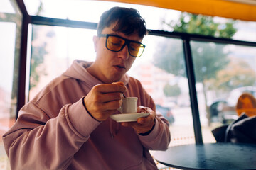 Freelance creative relaxing with coffee in softly lit autumn ambiance