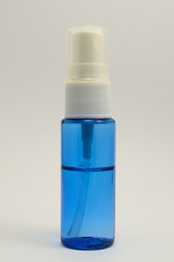 a small transparent spray bottle filled with blue liquid