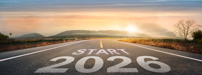 Fototapeta premium Start 2026 written on highway road in the middle of empty asphalt road of asphalt road at sunset.