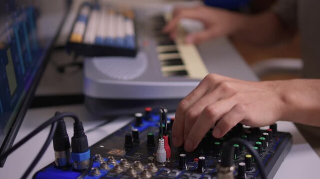 Closeup of tactile controls and vibrant patch cords in studio, Adjusting analog sequencing equipment with bright cables and warm ambient lighting in home studio