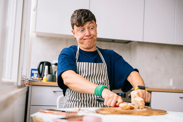 Person joyfully shares freshly baked bread with inviting demeanor