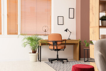 Interior of modern home office with stylish workspace and houseplant