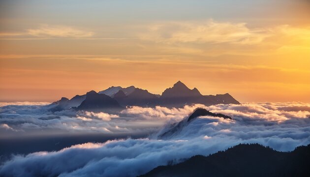 mountain range above clouds at sunrise