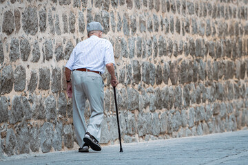 A man walks slowly down the deserted street.
