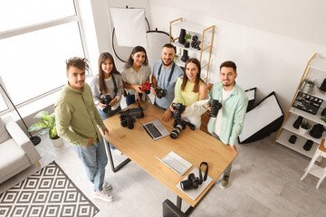Group of young photographers with cameras during courses in studio, top view