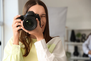 Fototapeta premium Female photographer with camera during courses in studio, closeup