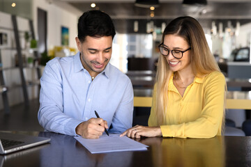 Fototapeta premium Positive business expert woman pointing at place for signature