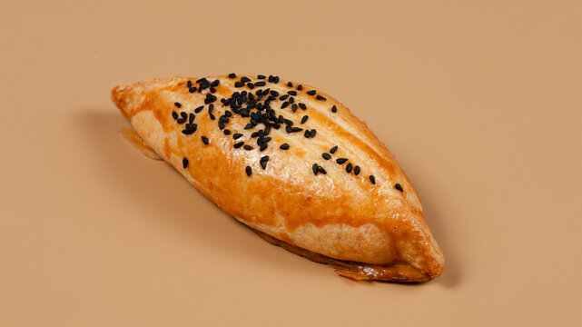 Pirozhki on beige background isolated
