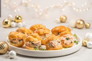 Smoked Salmon Cream Puffs served on a round plate with festive decorations