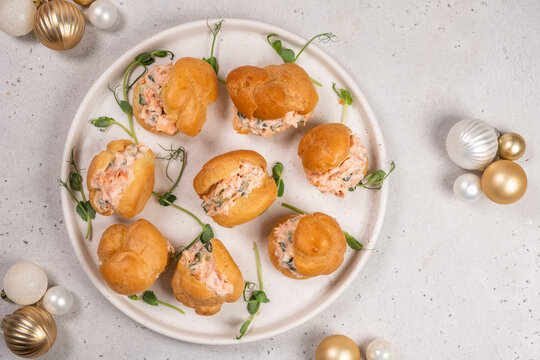 Smoked Salmon Cream Puffs served on a round plate with festive decorations