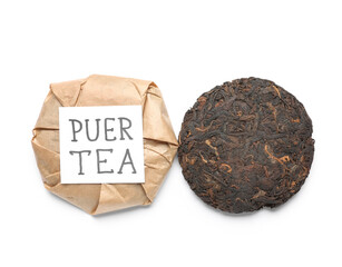 Dry pressed puer tea with sticky note on white background