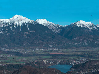 View of Lake Bled and the castle with the magnificent mountain range in the background: Stol, Vrtača, and Begunj&scaron;čica in the Karavanke Alps.