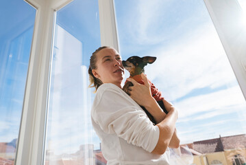 Affectionate woman displaying trust with vibrant feathered companion