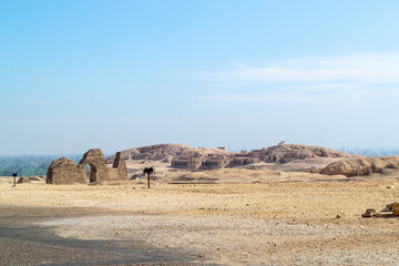 Egypt, Luxor, Hatshepsut temple 01.02.2022Ancient stone ruins with broken columns under harsh desert sunlight, warm earthy colors, historical archaeological theme