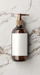 Brown bottle, gold pump, blank label on marble surface