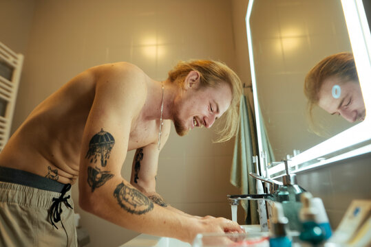 Personal selfcare routine captured in warm bathroom setting