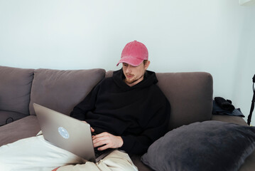 Young man concentrating on laptop in peaceful apartment setting