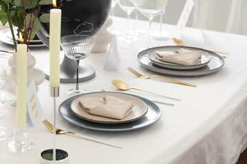 Table setting for Nobel prize day with burning candles in room
