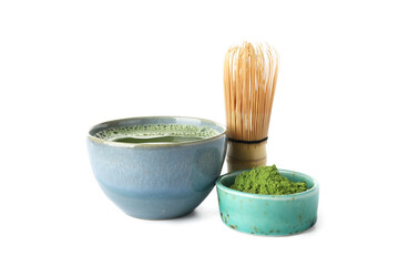 Bowls of fresh matcha tea and powder with chasen on white background
