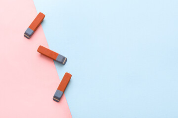 School erasers on color background