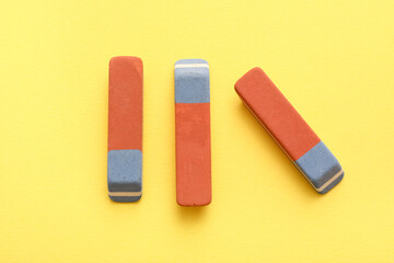 School erasers on yellow background