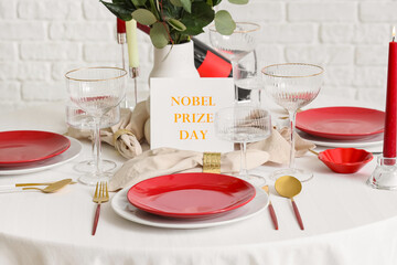 Elegant table setting for Nobel prize day with flowers and candles in dining room