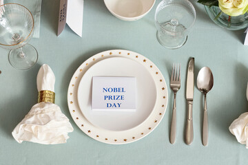 Elegant table setting for Nobel prize day with clean plates, top view