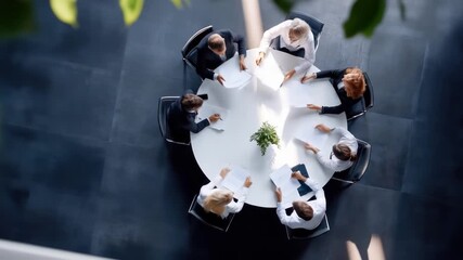 Business meeting in modern office with diverse team collaborating around circular table - Powered by Adobe