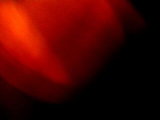 A blurry orange and red background. Light leak for a special effects or design use.
