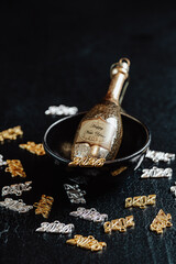 Several necklace pendants made of gold and silver, numbers 2026, and other decoration for the New Year's Eve celebration