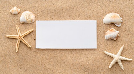 Blank white card surrounded by starfish and seashells on golden beach sand, providing ample copy space for text