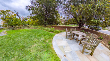 Outdoor furniture arrangement on circular flagstone platform