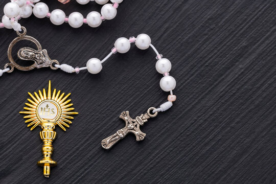 Catholic rosary and Golden religious symbol with IHS monogram