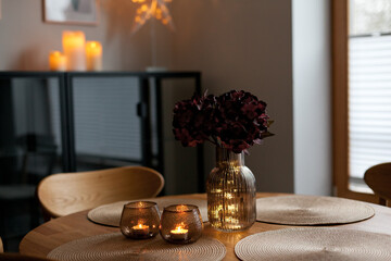 Led lights and interior decor on wooden table in scandinavian room. Hygge life style.