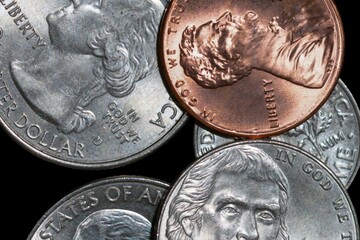 Close up of US coins isolated on black background