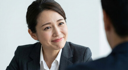 Negotiation in the Boardroom: In a sophisticated setting, two individuals engage in a meeting, with an emphasis on attentive communication, professional environment and effective discussion.