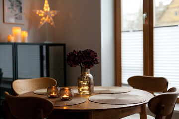 Led lights and interior decor on wooden table in scandinavian room. Hygge life style.