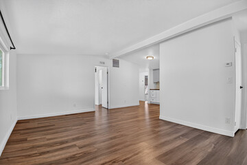 Generous Living Area Adorned With Timber Surfaces And Extensive Window Openings Suitable For Remodeling