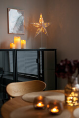Led lights and interior decor on wooden table in scandinavian room. Hygge life style.