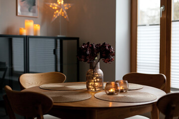 Led lights and interior decor on wooden table in scandinavian room. Hygge life style.