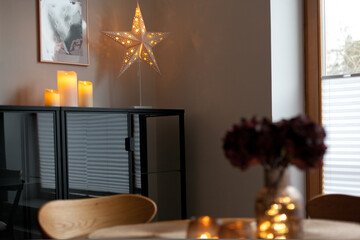 Led lights and interior decor on wooden table in scandinavian room. Hygge life style.