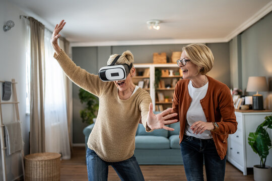 Senior women friends having fun with virtual reality