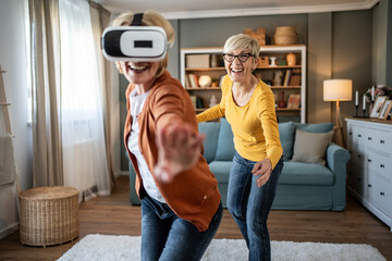 Seniors having fun playing virtual reality games at home