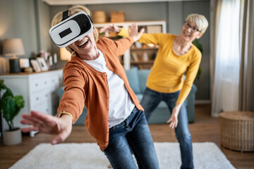 Senior women having fun playing virtual reality game