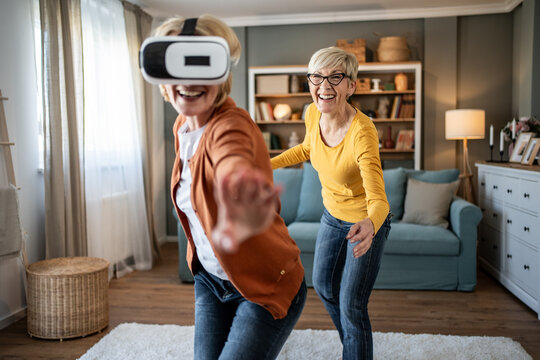 Seniors having fun playing virtual reality games at home